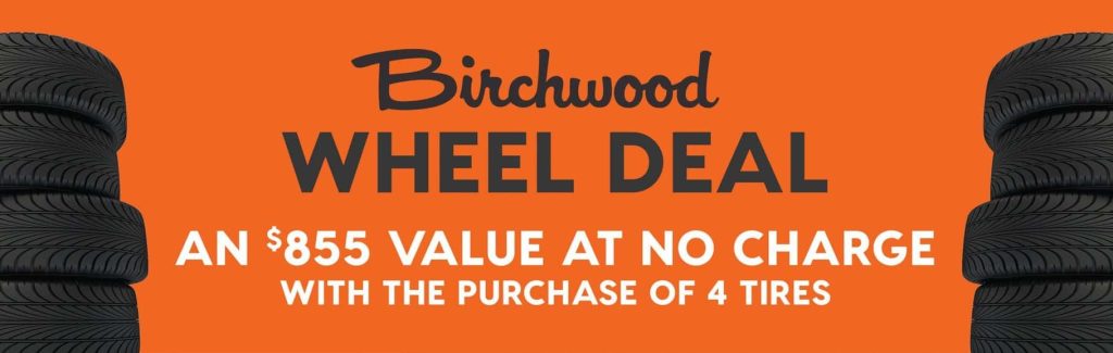 Birchwood Wheel Deal promotion on an orange background, featuring stacks of black tires on both sides and bold text stating “An $855 value at no charge with the purchase of 4 tires.”